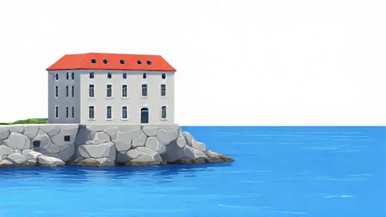 Edificio gris junto al agua azul